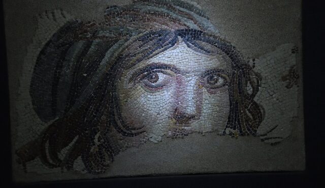 Zeugma’dan Çingene Kızı mozaiği: kıvırcık saçlı, iri gözlü, halka küpeli kadın portresi